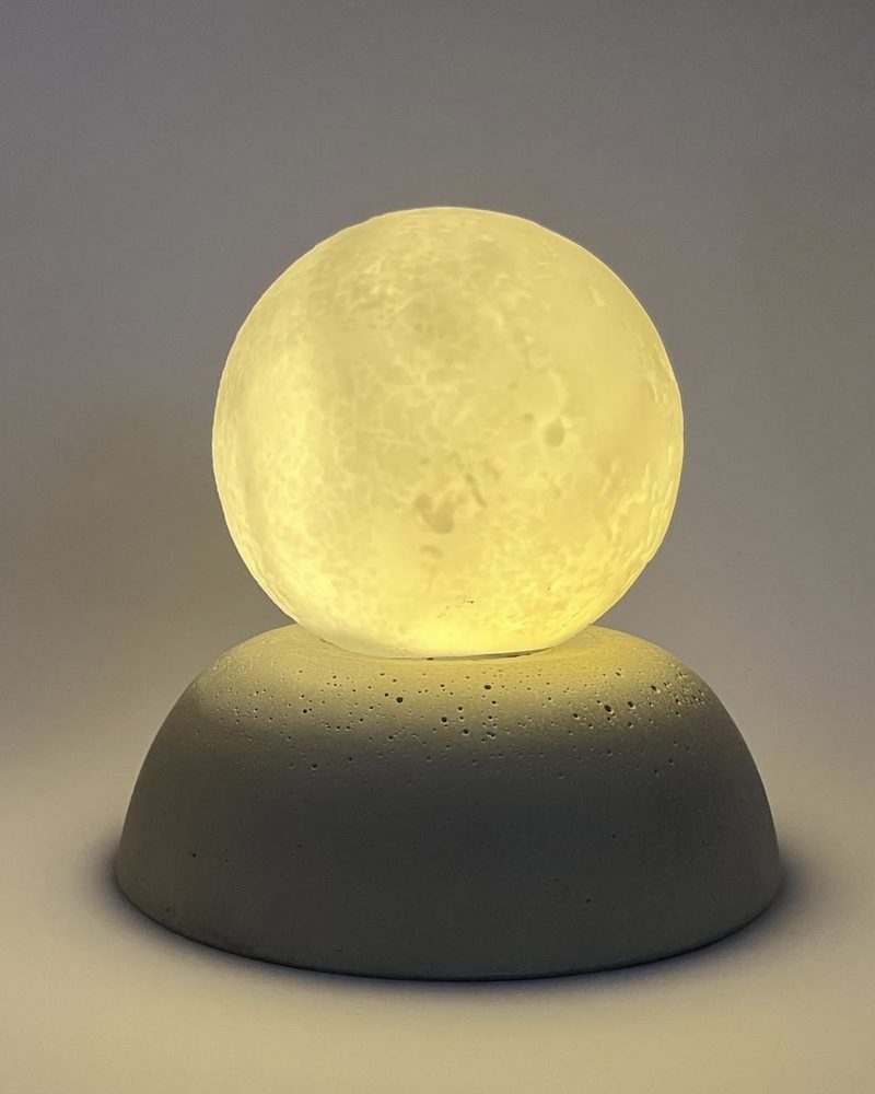 Glowing moon lamp on a concrete base
